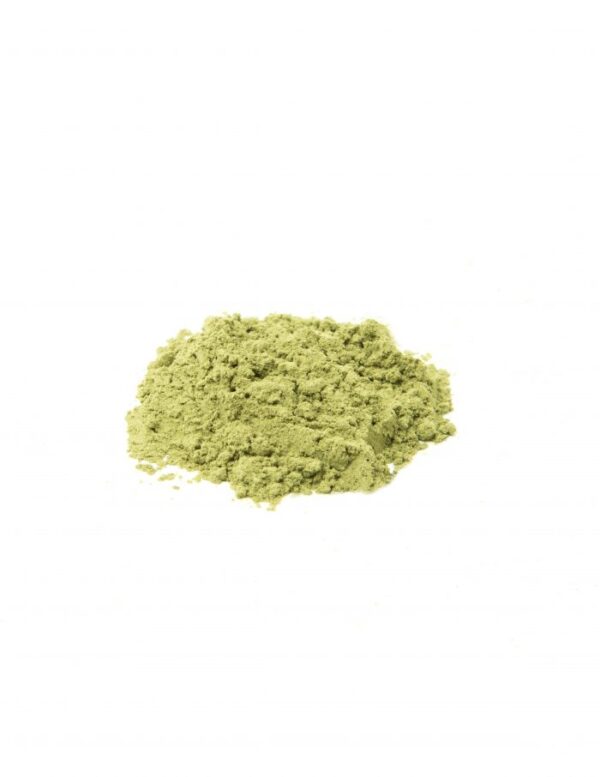 A pile of green powder on top of white surface.