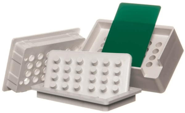 A group of white trays with green dividers.