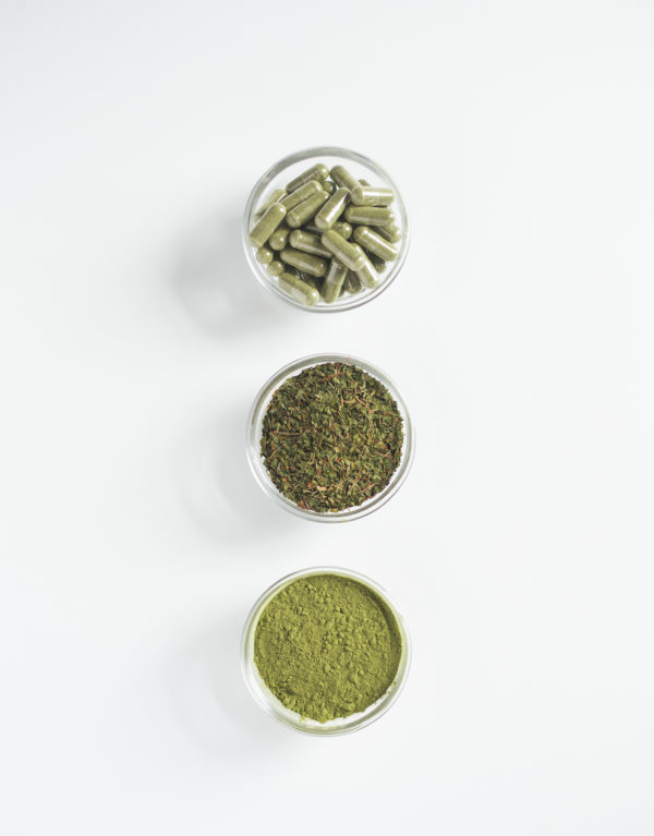 Three bowls of different types of green tea.