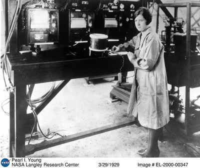 A black-and-white image of a woman with numerous devices